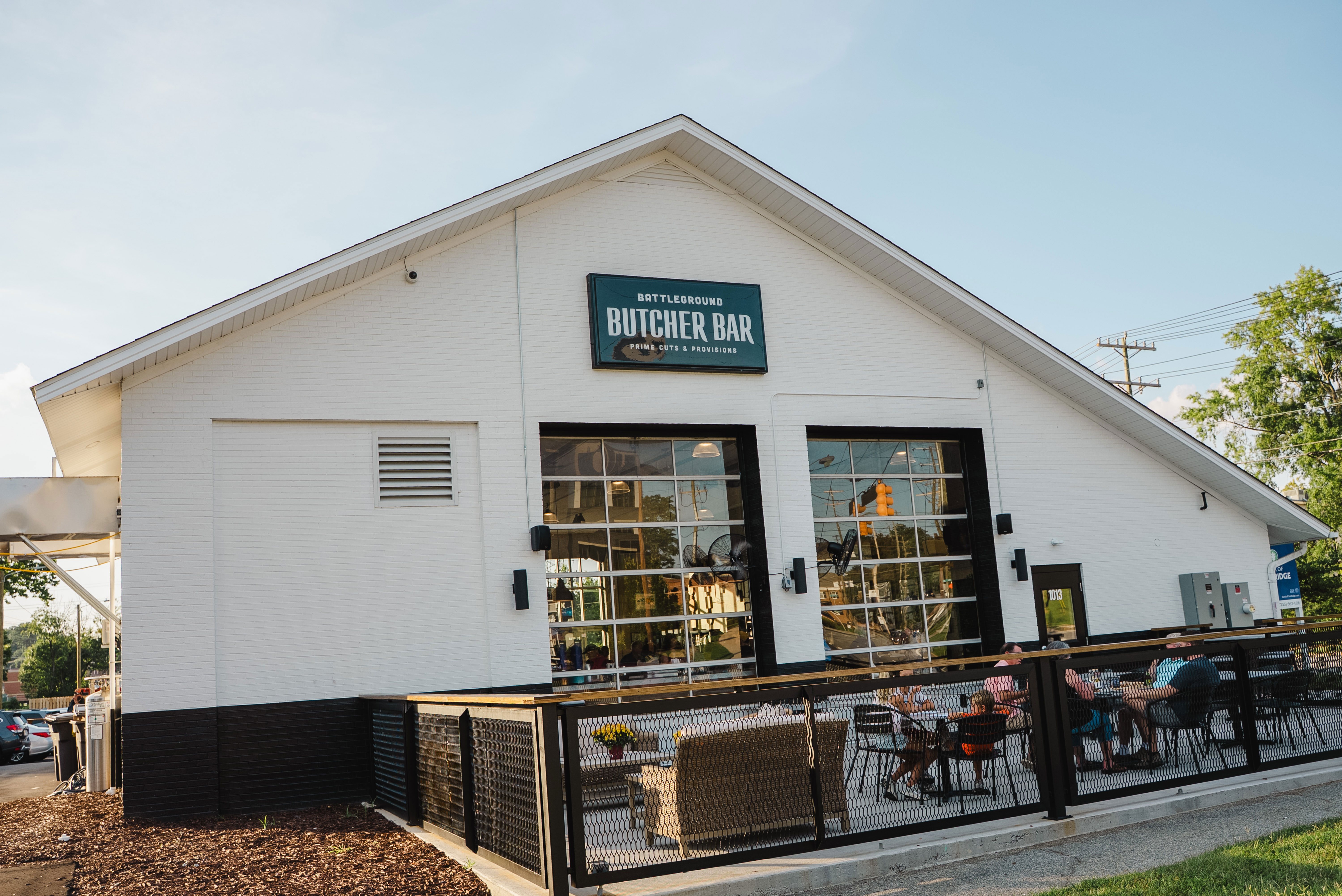Exterior view of Battleground Butcher Bar with outdoor seating area.