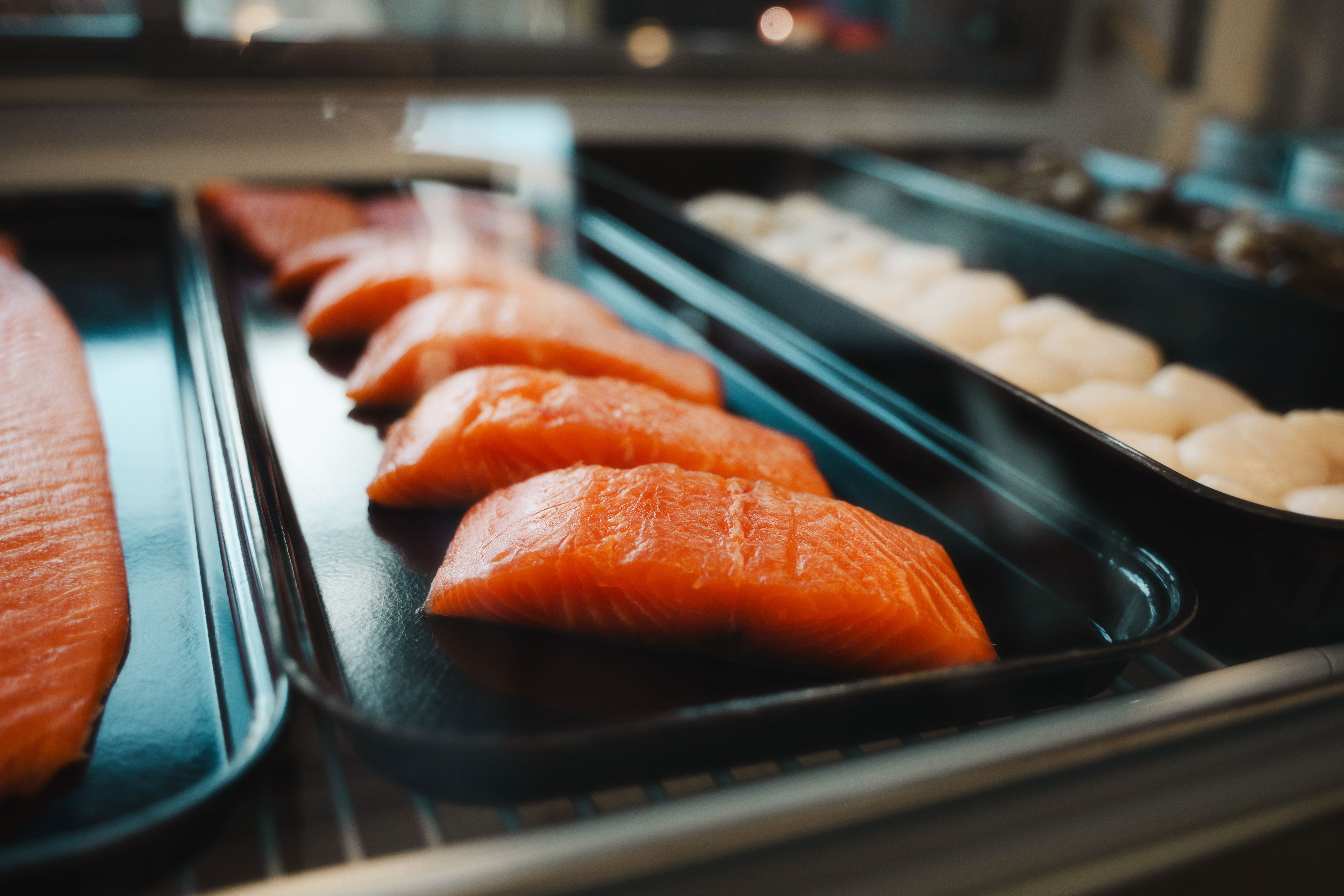 Fresh salmon fillets displayed at Battleground Butcher Bar in Butcher & Provisions.